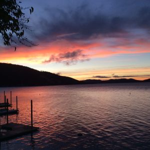 Julia Wilkinson's giclee print on canvas of sunset view of Clear Lake, California. Water with dark hills and red, pink blue sunset